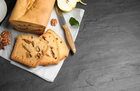 Flat lay composition with pear bread on black slate table, space for text. Ho Stock Photos