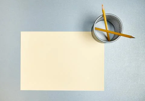 Flat lay composition of pencil holder and designer or watercolor paper on a g Stock Photos