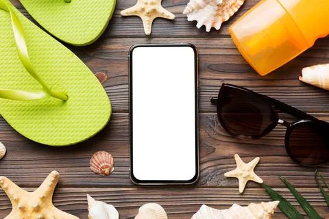 Flat lay composition with Phone and beach accessories on colored background.. Stock Photos