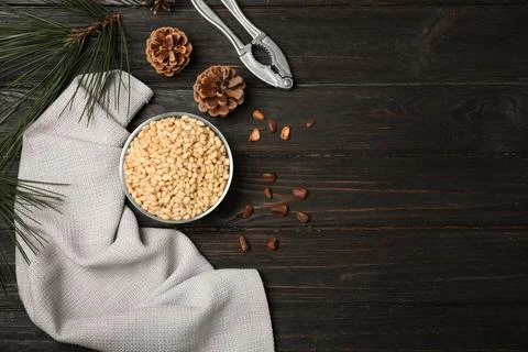 Flat lay composition with pine nuts on wooden background. Space for text Stock Photos