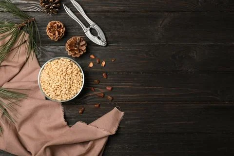 Flat lay composition with pine nuts on wooden background. Space for text Stock Photos
