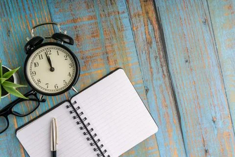 Flat lay composition of  plant  and vintage clock  on the wooden table Stock Photos