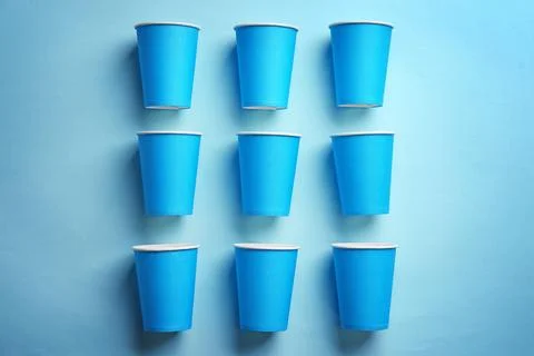 Flat lay composition with plastic cups on color background. Table setting Stock Photos
