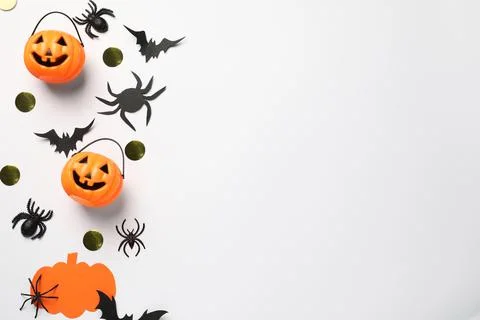 Flat lay composition with plastic pumpkin baskets, paper bats and spiders on  Stock Photos