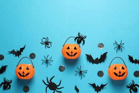 Flat lay composition with plastic pumpkin baskets, paper bats and spiders on  Stock Photos