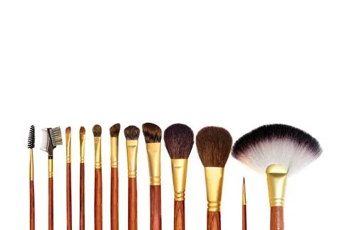 Flat lay composition with professional makeup brushes on white background Stock Photos