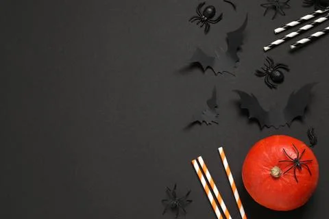 Flat lay composition with pumpkin, paper bats, spiders and cocktail straws on Stock Photos