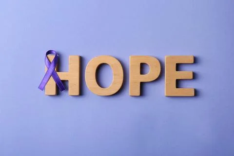 Flat lay composition with purple ribbon and word HOPE on violet background. D Stock Photos