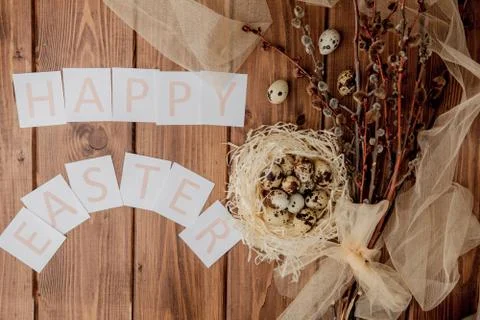 Flat lay composition of quail eggs and card with text Happy Easter on wooden  Stock Photos