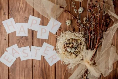 Flat lay composition of quail eggs and card with text Happy Easter on wooden  Stock Photos