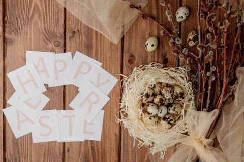 Flat lay composition of quail eggs and card with text Happy Easter on wooden  Stock Photos