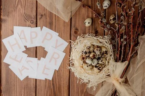 Flat lay composition of quail eggs and card with text Happy Easter on wooden  Stock Photos