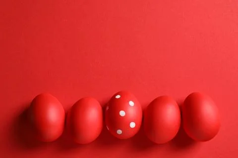 Flat lay composition of red painted Easter eggs on color background, space fo Stock Photos