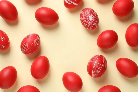 Flat lay composition of red painted Easter eggs on color background, space fo Stock Photos