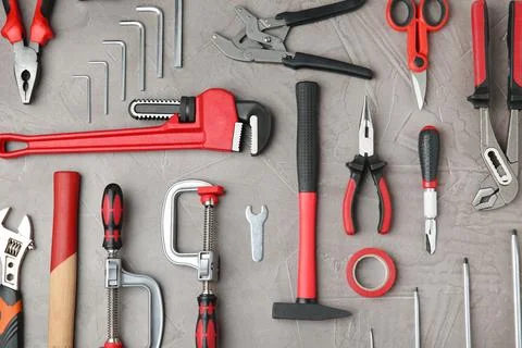 Flat lay composition with repair tools on grey stone table Fotos de archivo