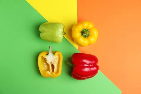 Flat lay composition with ripe bell peppers on color background Stock Photos