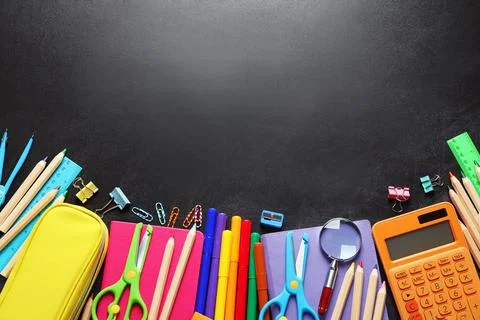 Flat lay composition with scissors and school supplies on dark background. Sp 库存照片