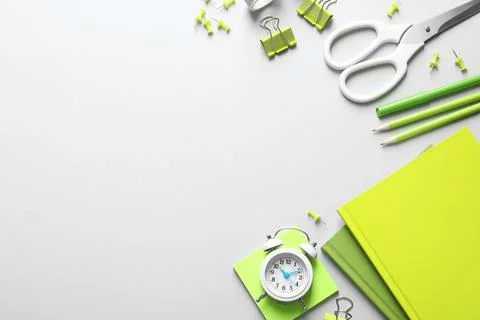 Flat lay composition with scissors and office supplies on grey background. Sp Stock Photos