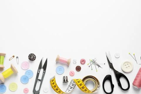 Flat lay composition with scissors and sewing supplies on white background. S Stock Photos