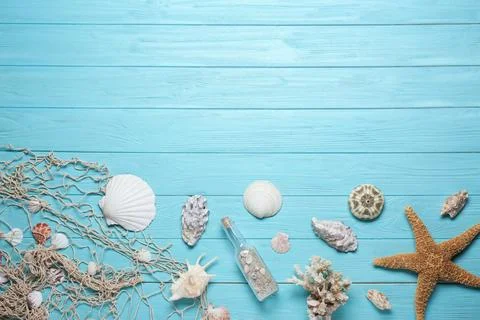 Flat lay composition with seashells and space for text on wooden background Stock Photos