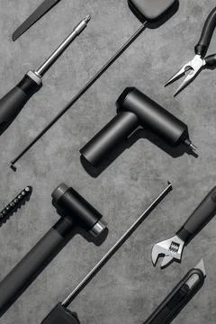 Flat lay composition with set of home repair tools on grey stone background. Stock Photos