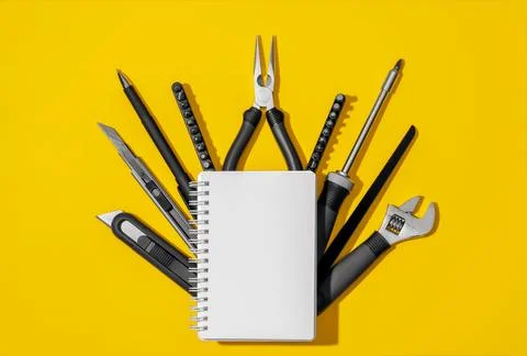 Flat lay composition with set of home repair tools and opened notebook on bright Stock Photos