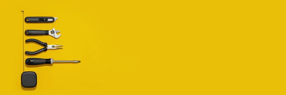 Flat lay composition with set of home repair tools on bright yellow background. Stock Photos
