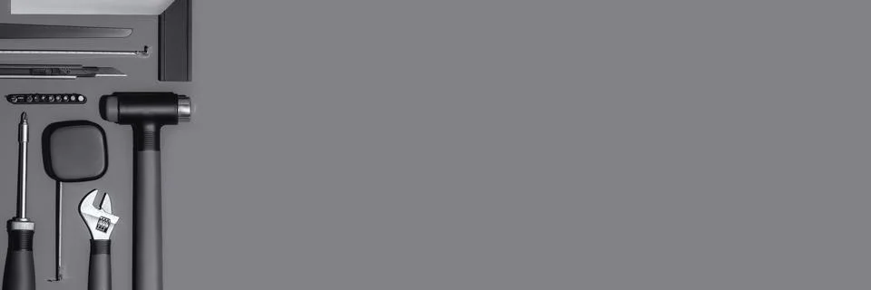 Flat lay composition with set of home repair tools on dark grey background. Stock Photos