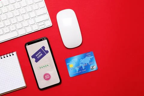 Flat lay composition of smartphone with activated promo code on red table. Sp Stock Photos