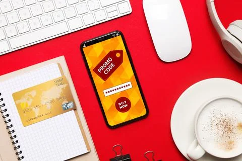 Flat lay composition of smartphone with activated promo code on red table Stock Photos