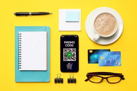 Flat lay composition of smartphone with activated promo code, credit cards an Stock Photos