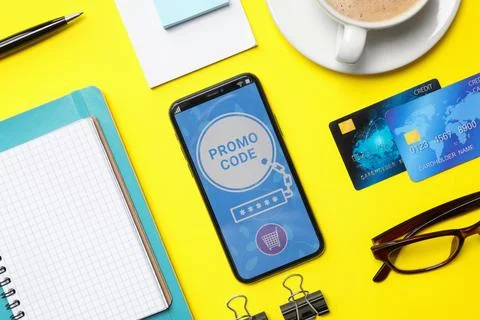 Flat lay composition of smartphone with activated promo code, credit cards .. Foto stock