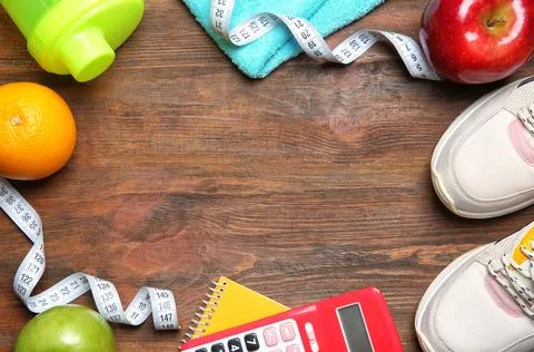 Flat lay composition with sneakers, healthy food, calculator and space for te Stock Photos