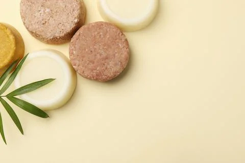 Flat lay composition of solid shampoo bars and leaf on beige background. Spac 写真素材