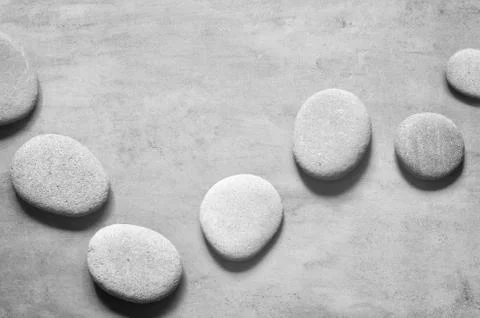 Flat lay composition with spa stones on grey background. Stock Photos