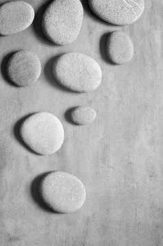 Flat lay composition with spa stones on grey background. Stock Photos