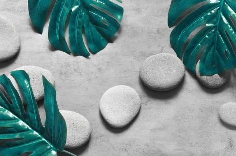 Flat lay composition with spa stones, palm leaves on grey background. Stock Photos
