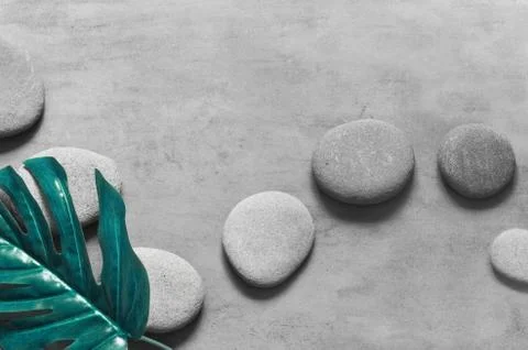 Flat lay composition with spa stones, palm leaves on grey background. Foto stock