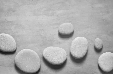 Flat lay composition with spa stones on grey background. Stock Photos