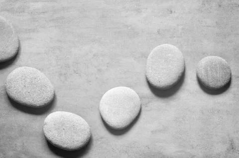 Flat lay composition with spa stones on grey background. Stock Photos