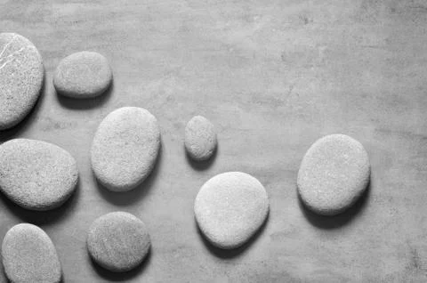 Flat lay composition with spa stones on grey background. Stock Photos