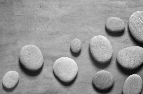 Flat lay composition with spa stones on grey background. Stock Photos