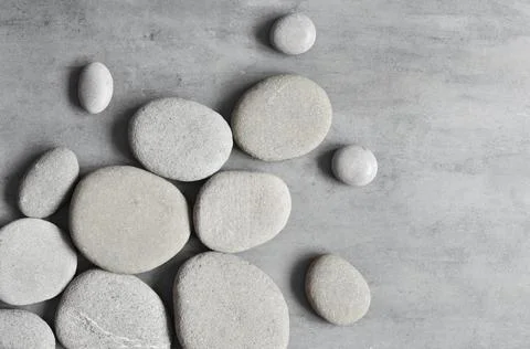 Flat lay composition with spa stones on grey background. Stock Photos