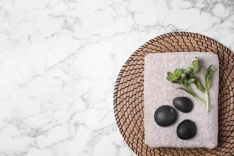 Flat lay composition with spa stones, towel and space for text on white marbl Stock-Fotos