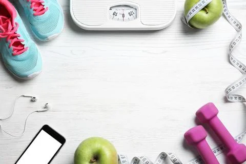 Flat lay composition with sport items, scales and space for text on wooden ba 스톡 사진