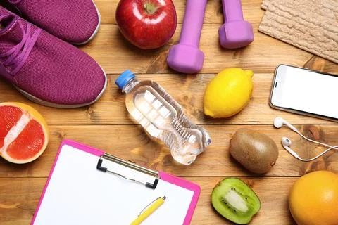 Flat lay composition with sport items, healthy food and clipboard on wooden b 스톡 사진