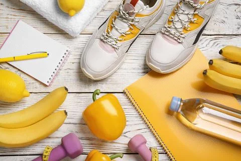 Flat lay composition with sport items, healthy food and notebooks on wooden b 스톡 사진