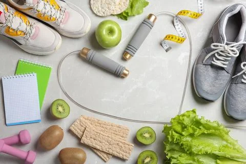 Flat lay composition with sport items, healthy food and space for text on gre 스톡 사진