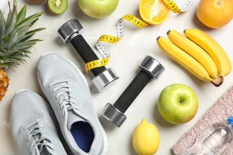 Flat lay composition with sport items and healthy food on grey background. We Stock Photos
