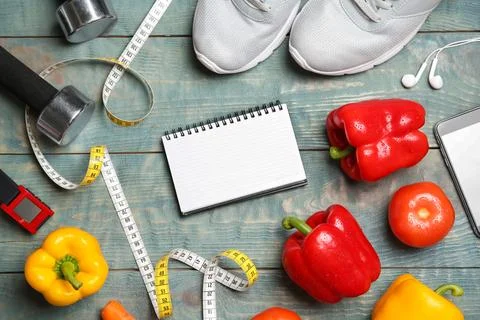 Flat lay composition with sport items, healthy food, notebook and space for t Stock Photos